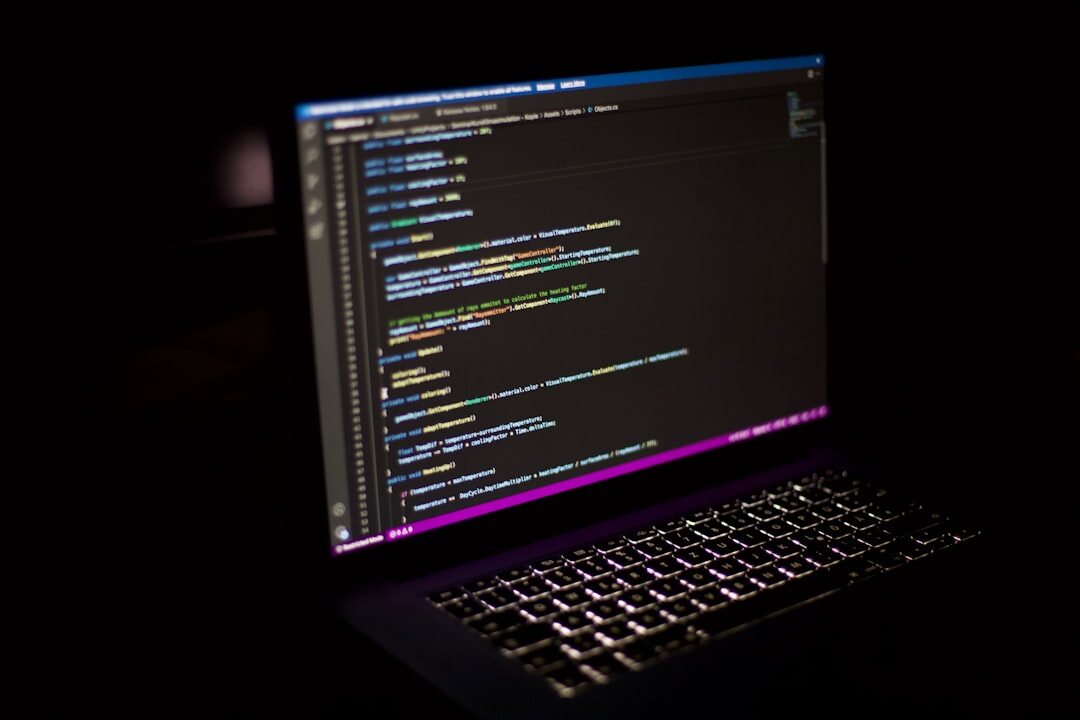 developer writing code on laptop