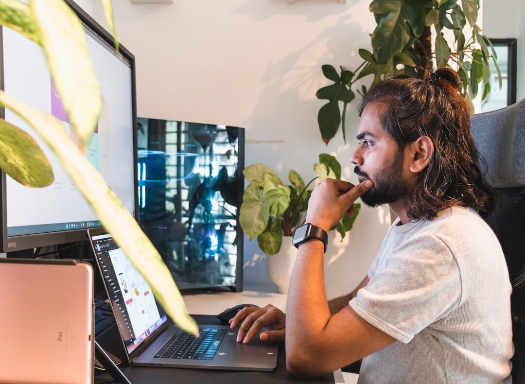person coding on laptop at desk